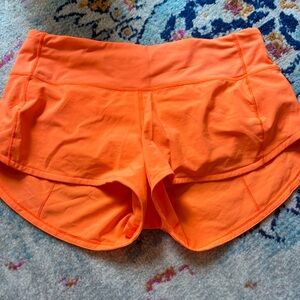 Lululemon 2.5 inch speed up low rise shorts in highlight orange. Size 4